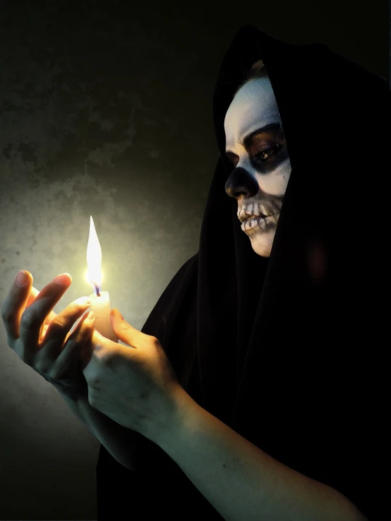 a close up of a person holding a lit candle, digital art, by Luis Molinari, shutterstock, vanitas, dia de los muertos makeup, woman in black robes, horror”, skelleton