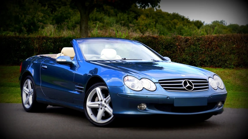 a blue convertible car parked on the side of the road, by Julian Allen, trending on pixabay, renaissance, mercedez benz, with a white muzzle, late 2000’s, edited