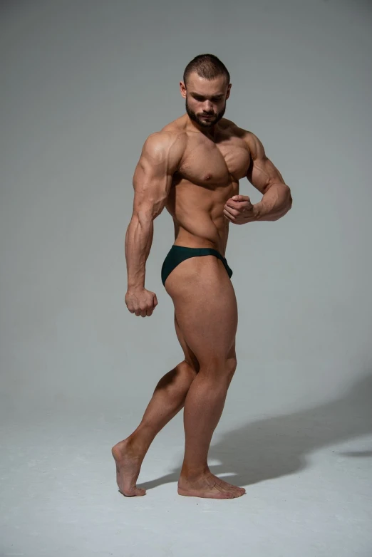 a male bodybuilde is posing for a picture, inspired by Volkan Baga, side pose, green body, dmitry prozorov style, thick legs