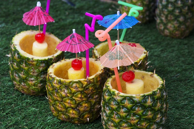 a group of pineapples sitting on top of a lush green field, bartending, decorated, in style of thawan duchanee, recipe