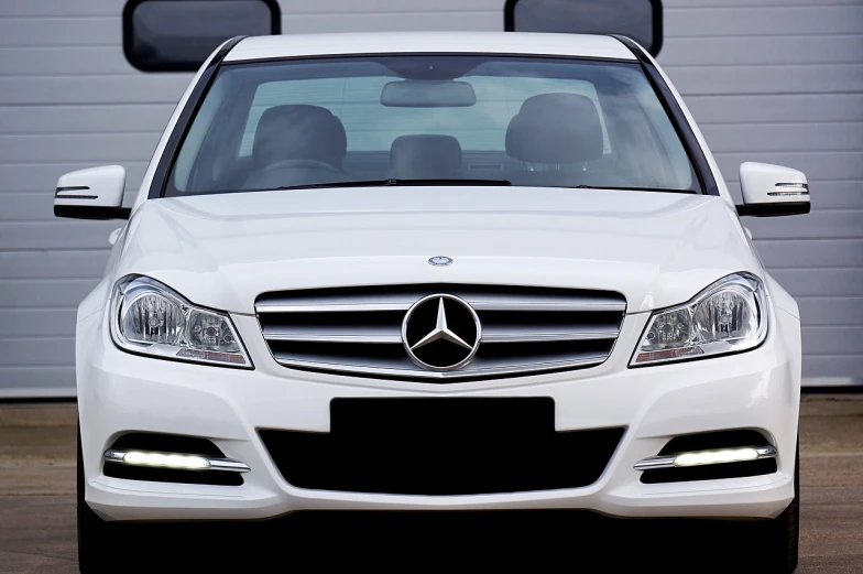 a white mercedes parked in front of a garage, by Julian Allen, trending on pixabay, custom headlights, trimmed with a white stripe, happy face, banner