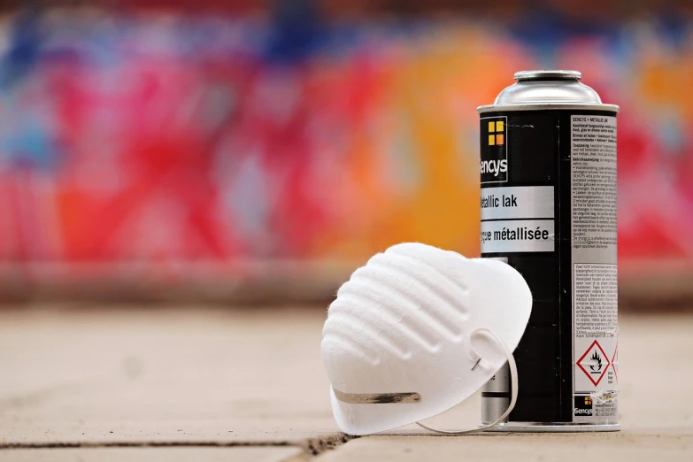 a can of spray paint next to a white helmet, graffiti, product photography 4 k, bauhaus style painting, dust mask, photograph credit: ap