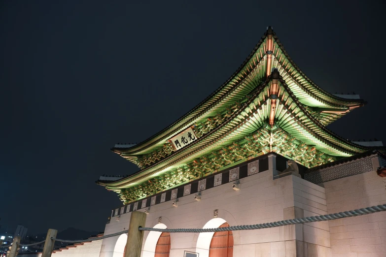 a building that is lit up at night, a picture, inspired by Kim Hong-do, shutterstock, low - angle shot, historic, big crown adorned with emerald, tourist photo