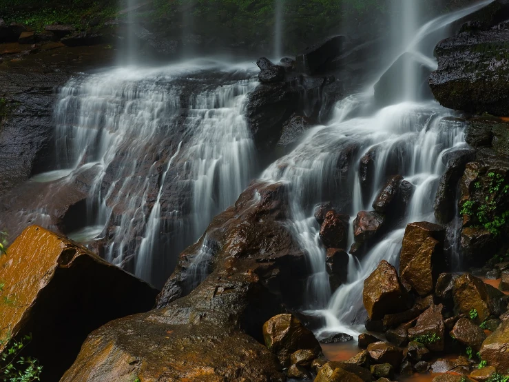 a waterfall in the middle of a lush green forest, a tilt shift photo, by Ivan Grohar, romanticism, 8k 50mm iso 10, endless flowing ethereal drapery, wet rocks, long exposure photo