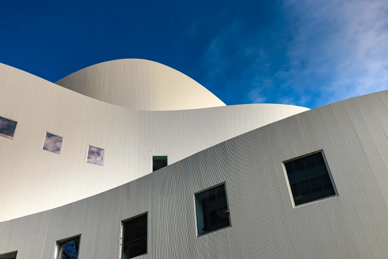 a white building with a blue sky in the background, by Doug Ohlson, flickr, modernism, beautiful curves, seattle, contrastive colors, museum photography