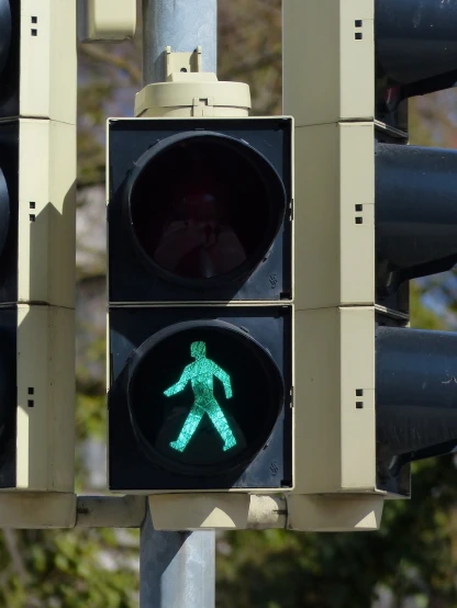 a traffic light with a green pedestrian sign on it, inspired by Bruce Nauman, figuration libre, hannover, photograph credit: ap, pictogram, green man