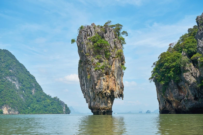 a rock formation in the middle of a body of water, by Richard Carline, shutterstock, thailand, a creature 5 meters tall, thin face structure, flying islands