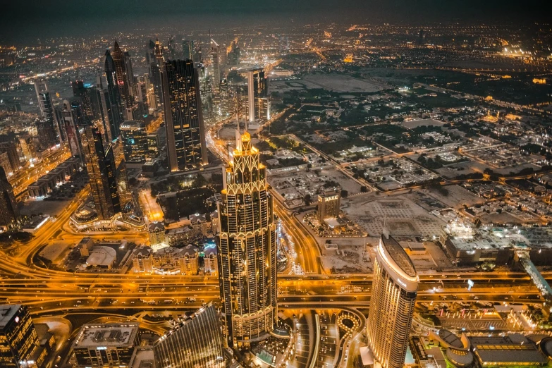 an aerial view of a city at night, a picture, by Bernardino Mei, pexels contest winner, gta : dubai, tall structures, city in backround, bird view