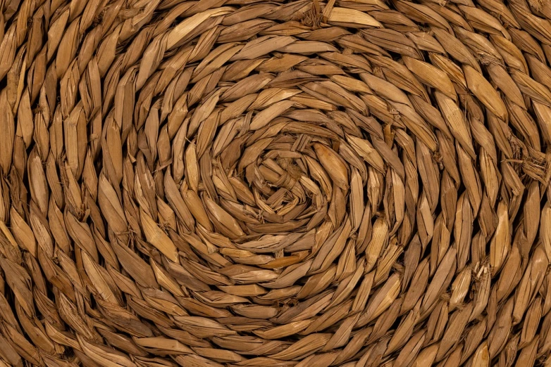 a close up view of a wicker basket, inspired by Andy Goldsworthy, trending on pexels, conceptual art, seamless texture, high detail spiral design, bottom - view, 35 mm product photo”