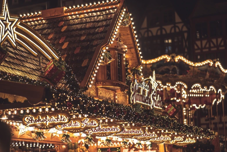 a christmas market with lots of lights and decorations, a photo, by Matthias Weischer, pexels, renaissance, peaked wooden roofs, 💋 💄 👠 👗, lit from the side, edited