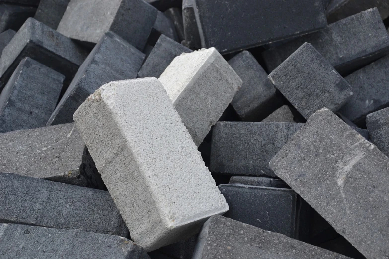 a pile of bricks sitting on top of each other, bauhaus, black sand, packshot, close up image, product introduction photo