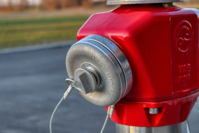 a red fire hydrant sitting on the side of a road, a portrait, by Kazimierz Wojniakowski, shutterstock, metal key for the doors, closeup photo, button potenciometers, circular