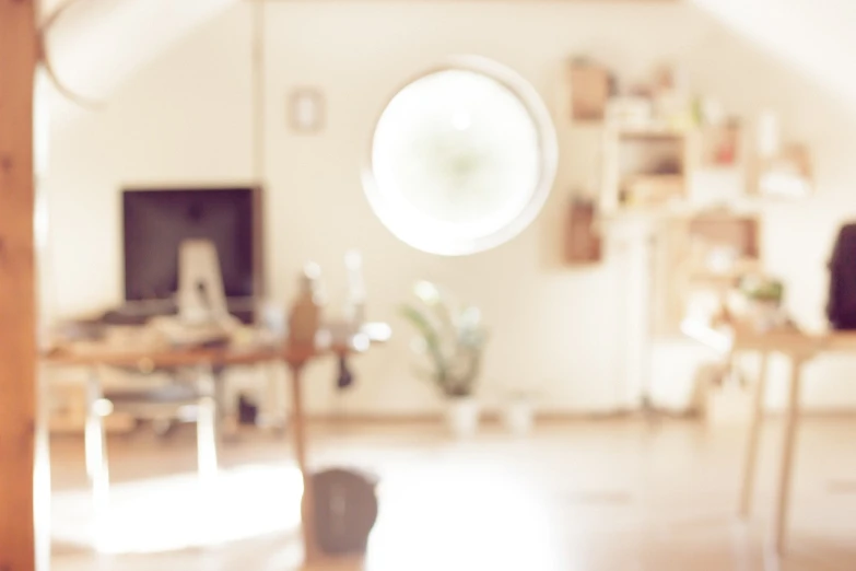 a living room filled with furniture and a round window, a picture, unsplash, light and space, rinko kawauchi, subtle lens flare, banner, short dof