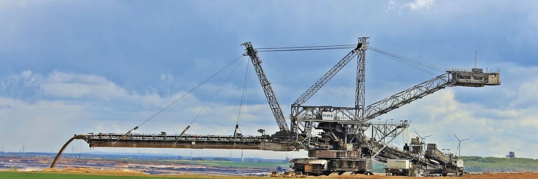 a large crane sitting on top of a field, by Werner Gutzeit, pixabay, intricate mine, terminal, side view of a gaunt, promo image