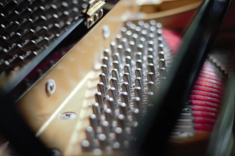 a close up of the keys of a piano, a macro photograph, by Matija Jama, precisionism, rivets, video still, intricately detailed scales, small depth of field