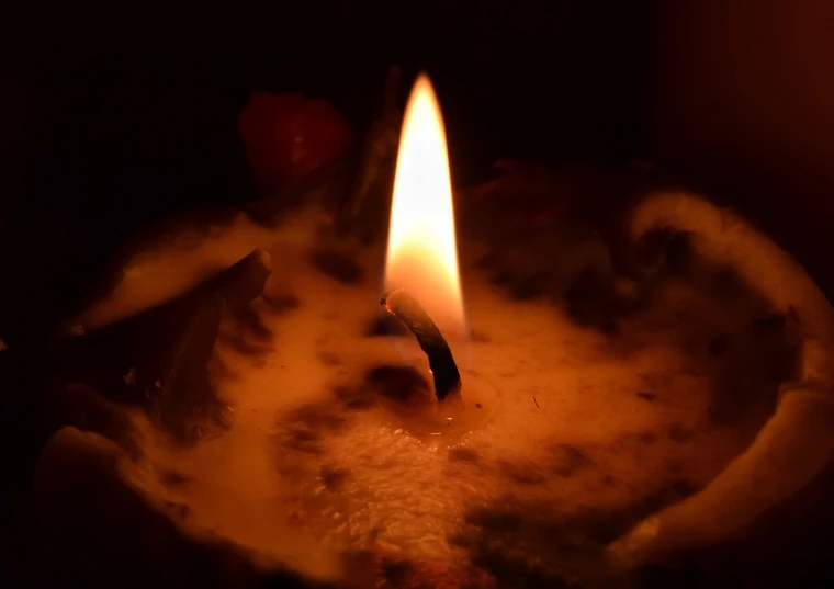 a close up of a lit candle in a bowl, a picture, light and dark, profile picture, wikimedia, medium close-up shot