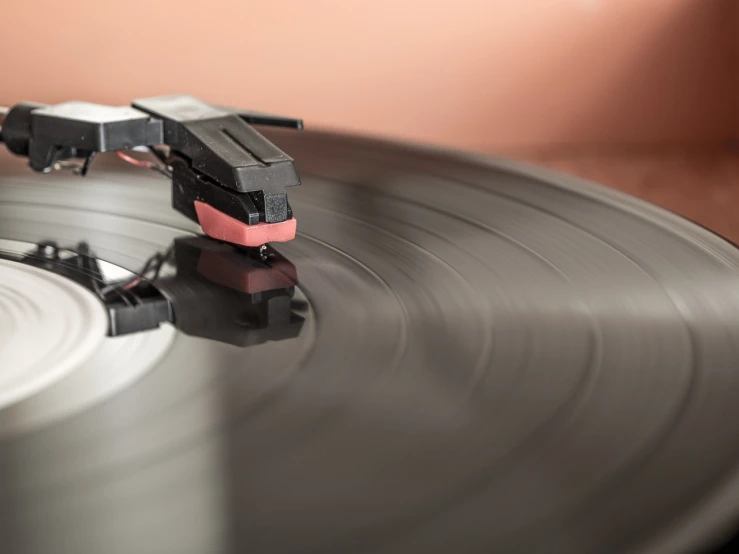 a close up of a record on a turntable, an album cover, by Hariton Pushwagner, shutterstock, slightly blurred, stock photo