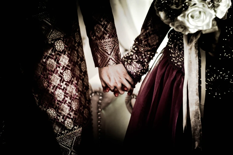 a close up of two people holding hands, by Basuki Abdullah, tumblr, sumatraism, ornate dark red opulent clothing, awww, oh yeah, islamic