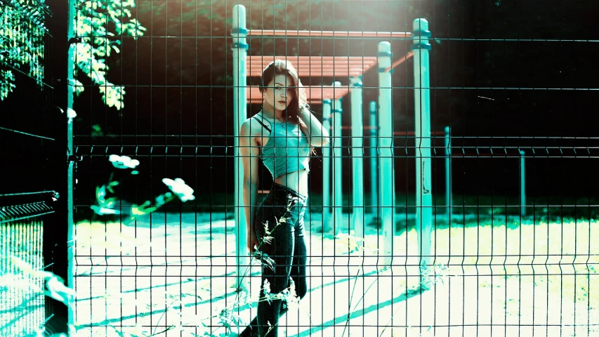 a woman standing in front of a fence, inspired by Elsa Bleda, art photography, cyberpunk 2 0 y. o model girl, korean women's fashion model, perfect composition and lighting, ((oversaturated))
