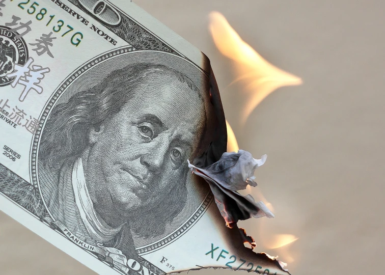 a burning dollar bill sitting on top of a table, a picture, by Adam Manyoki, unhappy, 6 4 0, istockphoto, demolition