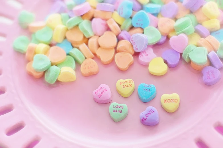 a pink plate with conversation hearts on it, a picture, pexels, pastell colours, beautiful wallpaper, cutecore, beads