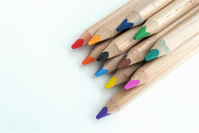 a group of colored pencils sitting next to each other, a pastel, close-up product photo