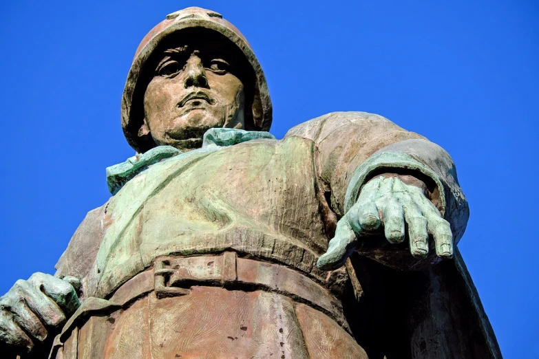 a close up of a statue with a blue sky in the background, a statue, figuration libre, doomguy as a soviet soldier, close-up from above, chilean, wearing a round helmet