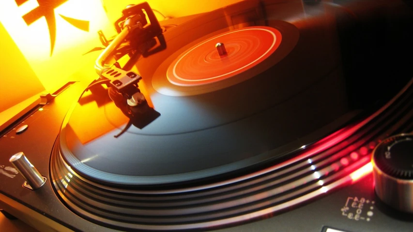 a record player sitting on top of a turntable, by Hariton Pushwagner, flickr, process art, orange glow, glossy reflections, my pov, taken in the late 2000s