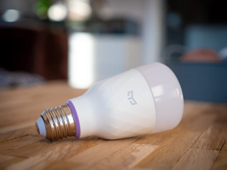 a white light bulb sitting on top of a wooden table, a picture, led purple eyes, product introduction photo, slightly pixelated, high detail product photo