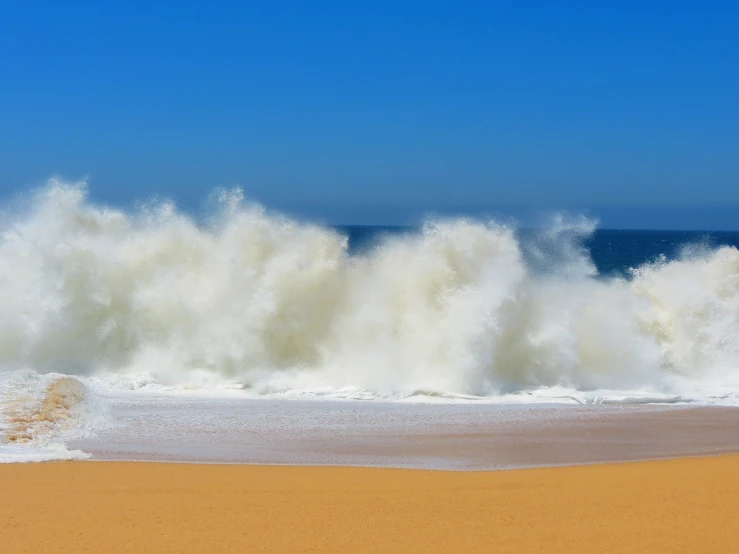 a man standing on top of a sandy beach next to the ocean, pexels, fine art, big wave and foam, farol da barra, today\'s featured photograph 4k, roaring ocean in front