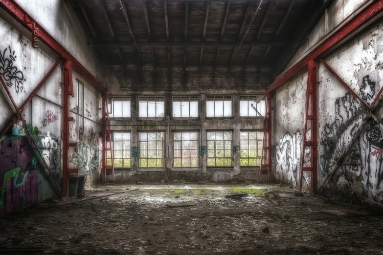 a room with lots of graffiti on the walls, by Daarken, pexels contest winner, abandoned night hangar, soft grey and red natural light, lots of windows, tonemapped