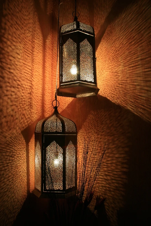 a couple of lamps hanging from the side of a wall, inspired by Riad Beyrouti, flickr, arabesque, fine stippled lighting, oriental wallpaper, warm shading, ultrafine detail ”