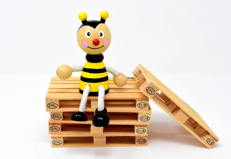 a wooden toy sitting on top of a pallet, a picture, inspired by Jan Konůpek, pexels, figuration libre, bee movie, chest legs, 2 4 mm iso 8 0 0, hong soonsang