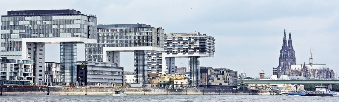 a large body of water surrounded by tall buildings, inspired by Victor Enrich, pixabay, art nouveau, skybridges, view from the sea, hoog detail, herzog de meuron