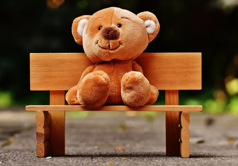 a teddy bear sitting on a wooden bench, a picture, by Niko Henrichon, trending on pixabay, very very happy, plushy, tocchini, protective