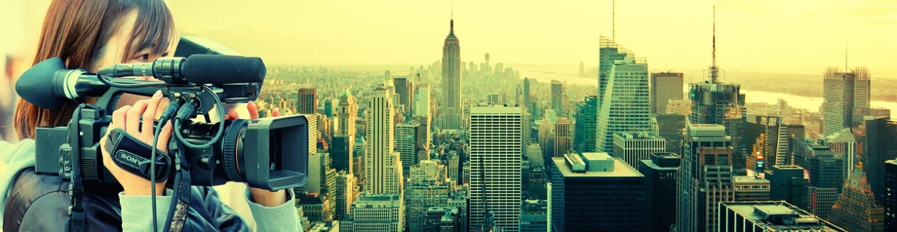 a woman taking a picture of a city with a camera, a picture, modernism, empire state building, with a yellow green smog sky, abcdefghijklmnopqrstuvwxyz, vinyl