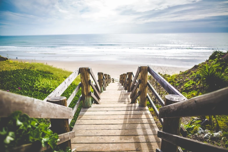 a wooden walkway going down to the beach, a stock photo, renaissance, round about to start, beach is between the two valleys, outdoor staircase, usa-sep 20