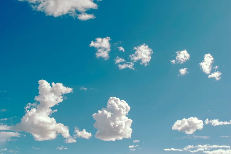 a man flying a kite on top of a lush green field, pexels, minimalism, giant cumulonimbus cloud, light blues, sitting in a fluffy cloud, clemens ascher