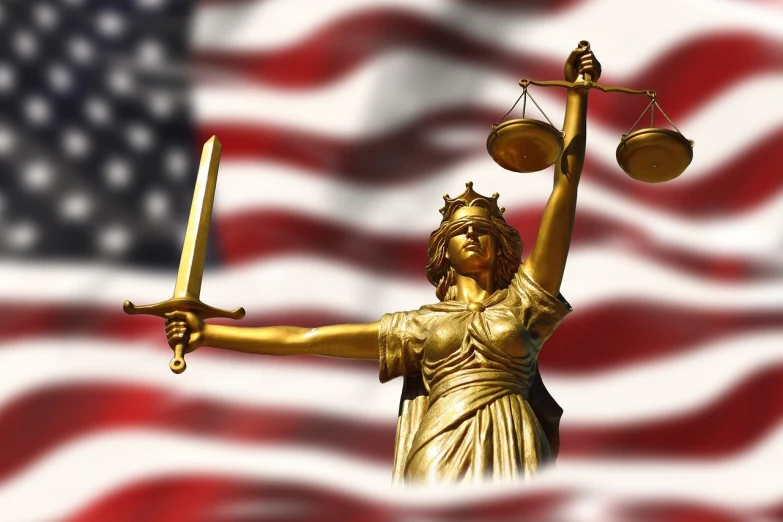 a statue of lady justice holding a sword in front of an american flag, a statue, background image, watch photo, dimensional, many years gone