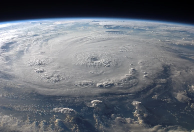 a view of the earth from the international space station, a picture, by Tom Carapic, shutterstock, apocalypse hurricane storm, round-cropped, all enclosed in a circle, looking partly to the left