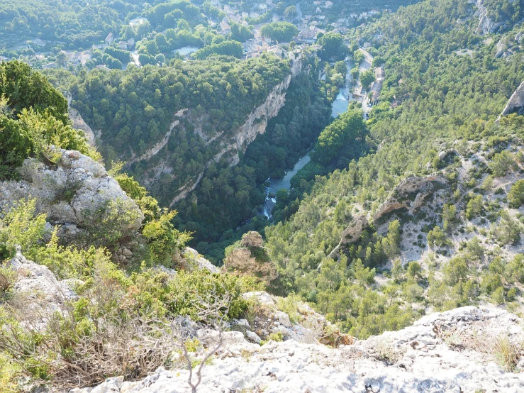 a man standing on top of a cliff next to a river, les nabis, as seen from the canopy, very very very very beautiful!!, looking downwards, over a calanque