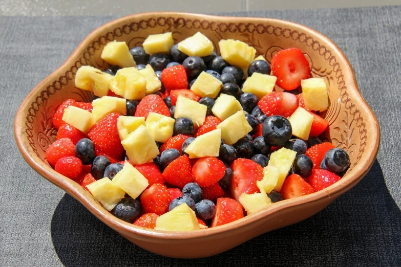 a bowl filled with strawberries, blueberries, and pineapples, a photo, image, salad, brazilian, rectangular