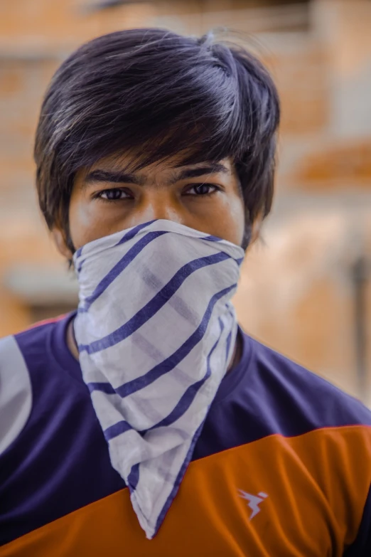 a close up of a person wearing a face mask, a picture, by Richard Carline, shutterstock, realism, india, male teenager, bandana, stock photo