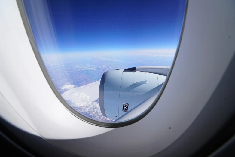 a view of the wing of an airplane through a window, a picture, usa-sep 20, space tourism, view for miles, looking at porthole window