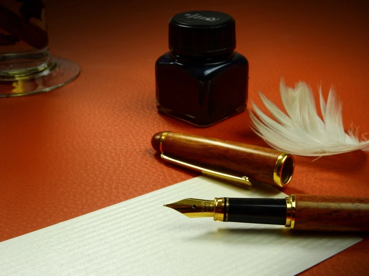 a pen sitting on top of a piece of paper next to a feather, a still life, very sharp photo, fancy background, professional product photo