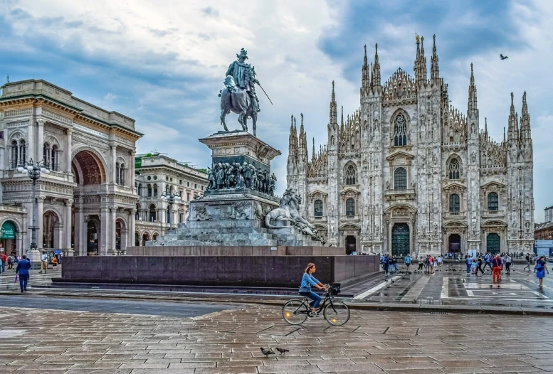 a statue of a man riding a bike in front of a cathedral, a statue, by Mirabello Cavalori, beautiful city of the future, giorgio vasari, photo from 2022, worst place to live in europe