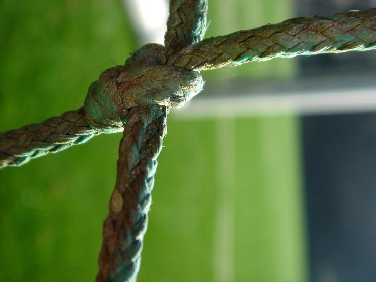 a close up of a knot on a rope, by Karel Štěch, flickr, green lines, soccer, verdigris, seams