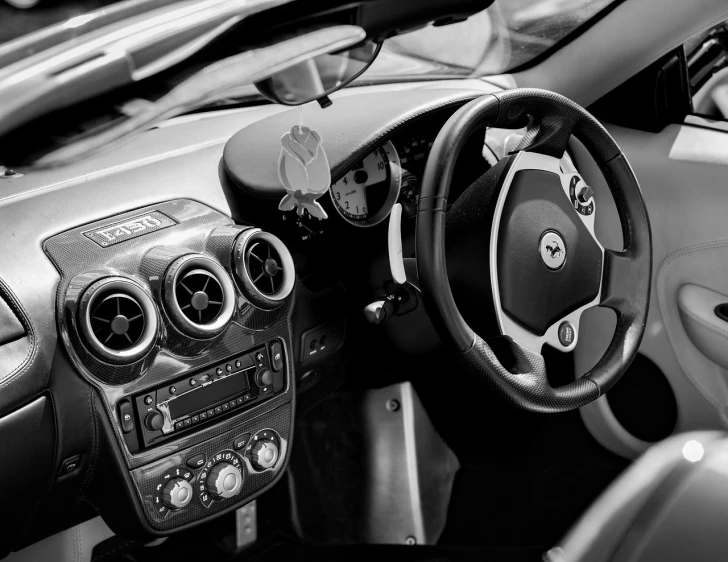 a black and white photo of a car dashboard, by Julian Allen, pexels, fine art, art nouveau ferarri car, apple car, black and white spots, convertable