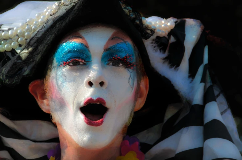 a close up of a person with a painted face, inspired by Bernd Fasching, flickr, kitsch movement, mime, watch photo, glamorous composition, singing