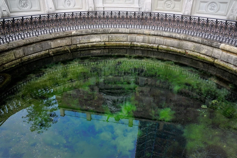 a bridge over a body of water with a building in the background, a picture, by Jan Rustem, flickr, baroque, green oozing pool pit, mirror texture, underwater westminster, mausoleum